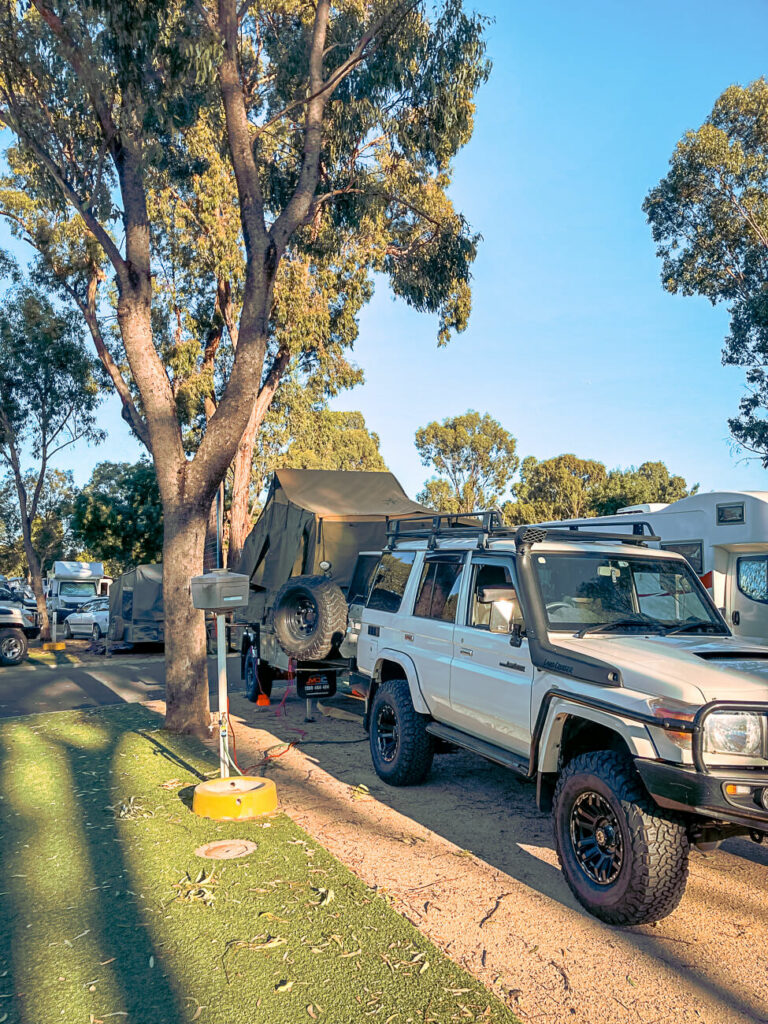 Car and camper trailer parked at the synthetic drive thru sites at NRMA Echuca Holiday Park