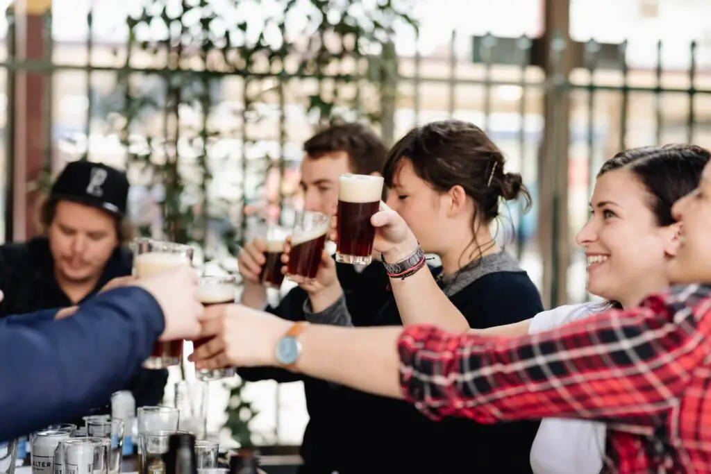 People enjoy glasses of beer. Beer lovers will enjoy Good Beer Week in Melbourne.