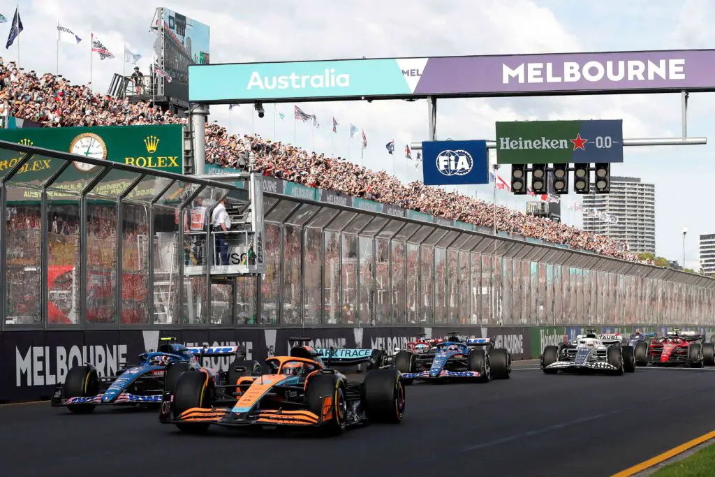 Cars racing as part of the Formula 1 Grand Prix. It's one of Melbourne's most popular events.