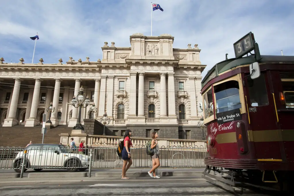 One of the vintage W-class City Circle trams in front of Parliament House - this is a great way to entertain kids in Melbourne!
