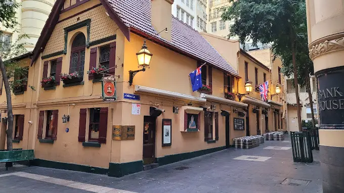 The exterior of The Mitre Tavern, one of several haunted pubs in Melbourne. The pub is an old-fashioned architecture, painted a beige colour with green trim and brown roof